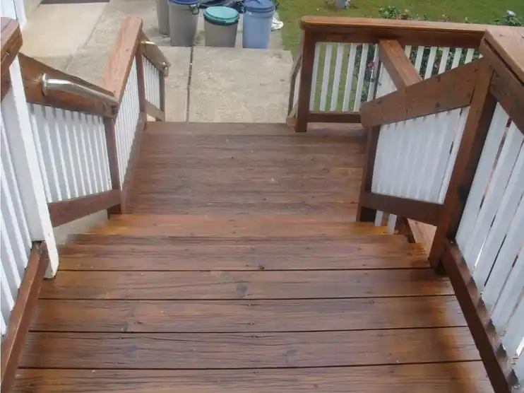 The same deck stairs stained, with white rails