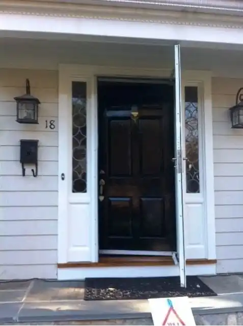 The same entry door refinished in black with white trim