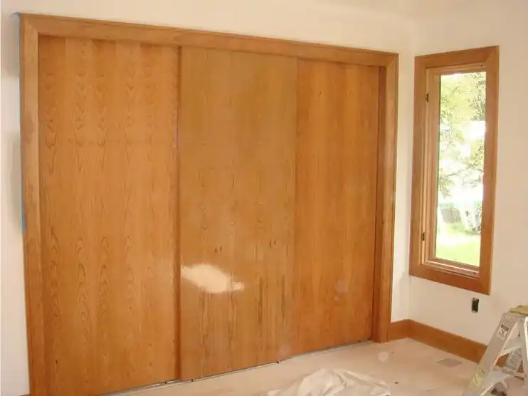 The same closet doors refinished in warm wood